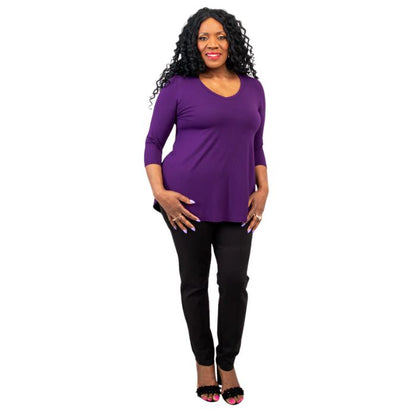 female model wearing royale purple jackie top and black nadia pants front view on white backround