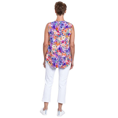 female model wearing violet fiesta print jackie tank top and white nadine cropped pants back view on white backround