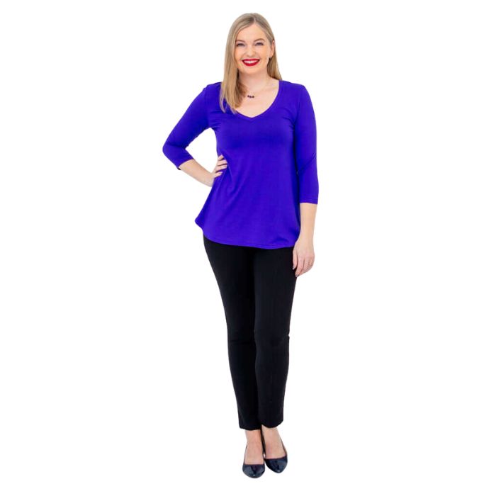 female model wearing violet purple jackie top and black nadia pants front view on white backround