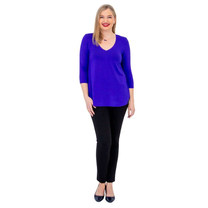 female model wearing violet purple jackie top and black nadia pants front view on white backround
