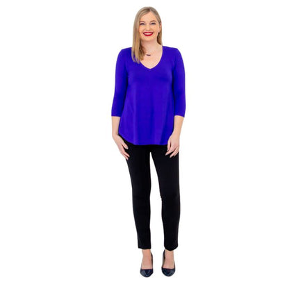 female model wearing violet purple jackie top and black nadia pants front view on white backround