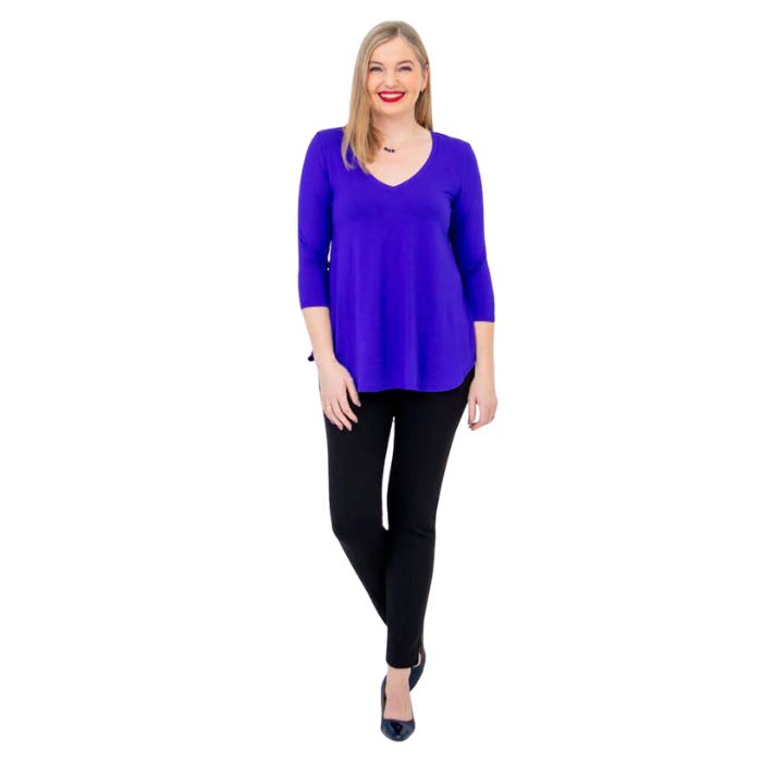 female model wearing violet purple jackie top and black nadia pants front view on white backround