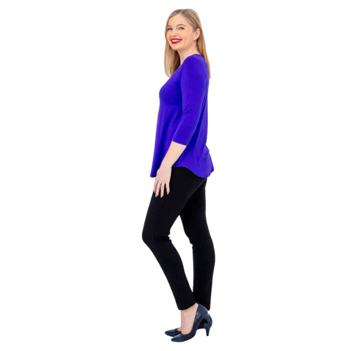 female model wearing violet purple jackie top and black nadia pants side view on white backround