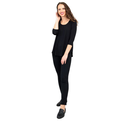 female model wearing jazz black three quarter sleeve top and nadia black pants front view on white background