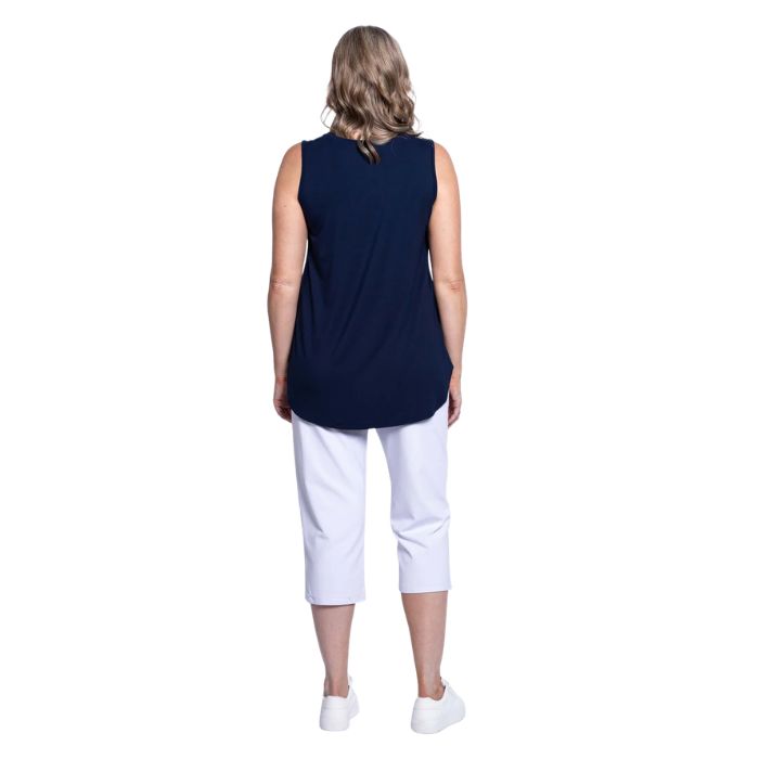 female model wearing indigo blue jazz tank top and white susan cropped pants back view on white background