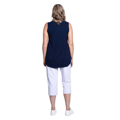 female model wearing indigo blue jazz tank top and white susan cropped pants back view on white background
