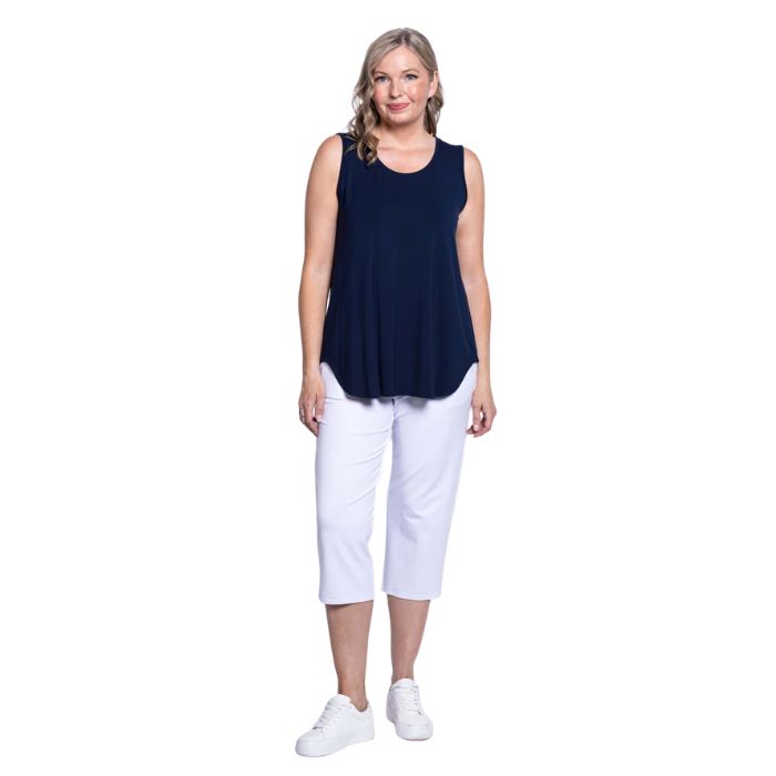 female model wearing indigo blue jazz tank top and white susan cropped pants front view on white background