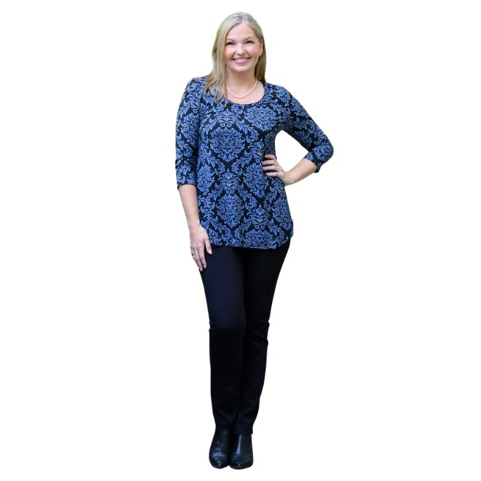 a woman wearing indigo empire print jazz top and indigo blue nadia pants front view on white backgrouna