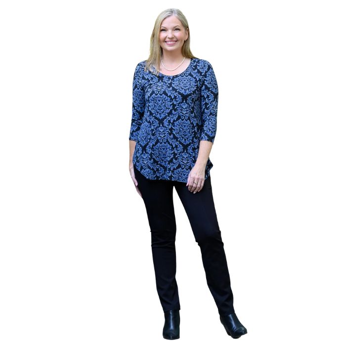 a woman wearing indigo empire print jazz top and indigo blue nadia pants front view on white backgrouna