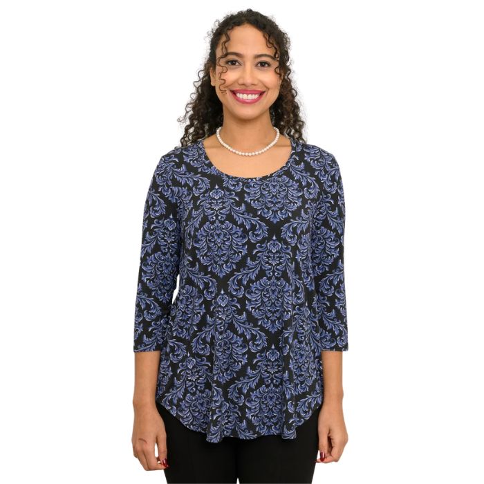 a woman wearing indigo empire print jazz top waist up front view on white backgrouna