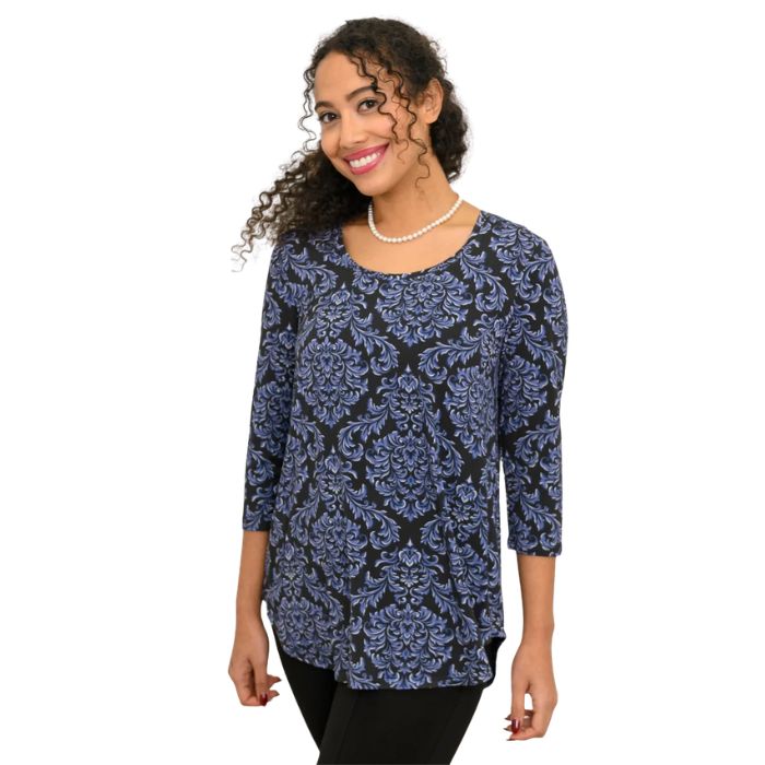a woman wearing indigo empire print jazz top waist up side view on white backgrouna