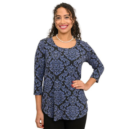 a woman wearing indigo empire print jazz top waist up front view on white backgrouna