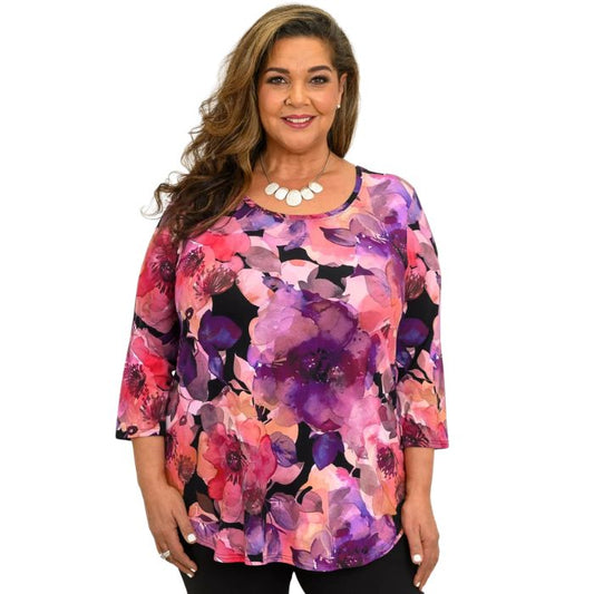 a women wearing royale garden print jazz top waist up front view on white background