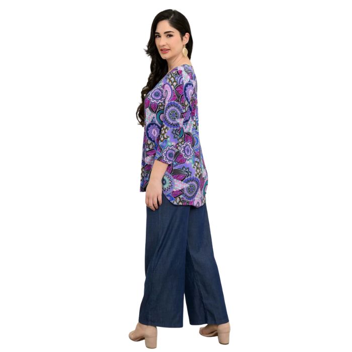 female model wearing jazz royale peacock print three quarter sleeve top and denim blue parker pants side view on white background