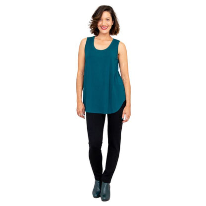 female model wearing teal green jazz tank top and black nadia pants front view on white background