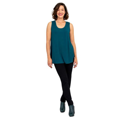 female model wearing teal green jazz tank top and black nadia pants front view on white background