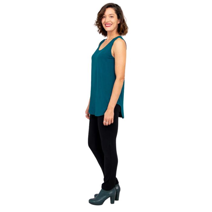 female model wearing teal green jazz tank top and black nadia pants side view on white background