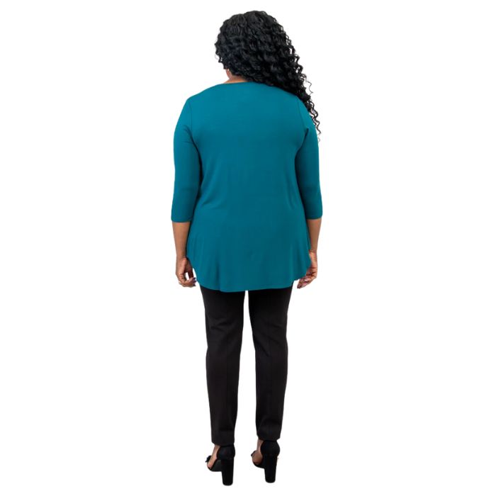 female model wearing jazz teal green three quarter sleeve top and nadia black pants back view on white background