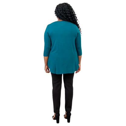 female model wearing jazz teal green three quarter sleeve top and nadia black pants back view on white background