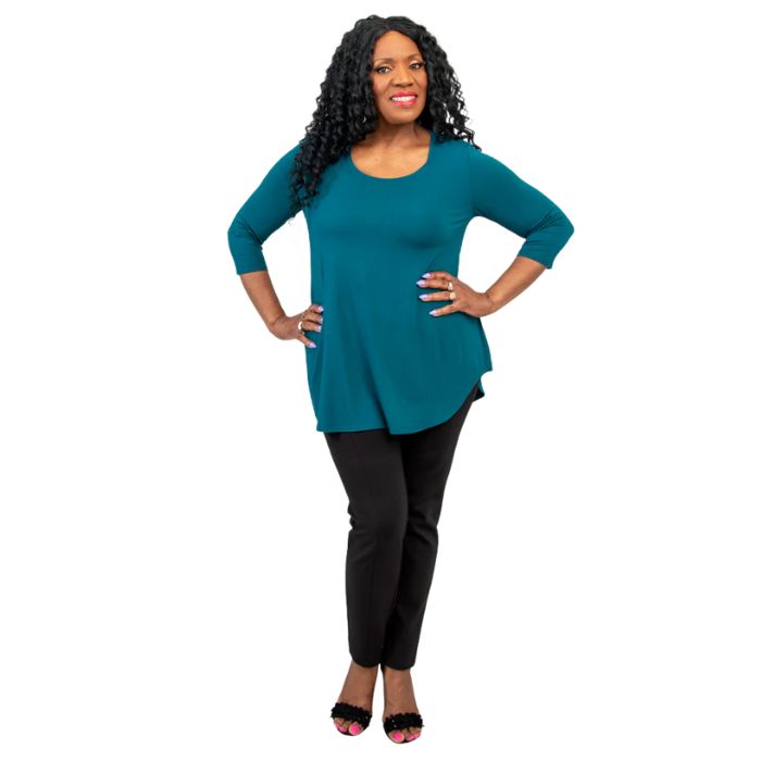 female model wearing jazz teal green three quarter sleeve top and nadia black pants front view on white background