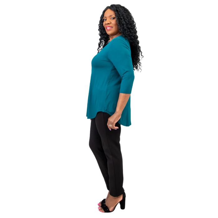female model wearing jazz teal green three quarter sleeve top and nadia black pants side view on white background