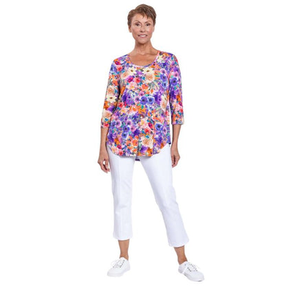 female model wearing jazz violet fiesta print three quarter sleeve top and white nadine cropped pants front view on white background