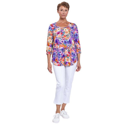 female model wearing jazz violet fiesta print three quarter sleeve top and white nadine cropped pants front view on white background