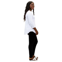 female model wearing jazz white three quarter sleeve top and nadia black pants side view on white backgrounde