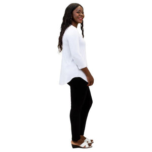 female model wearing jazz white three quarter sleeve top and nadia black pants side view on white backgrounde