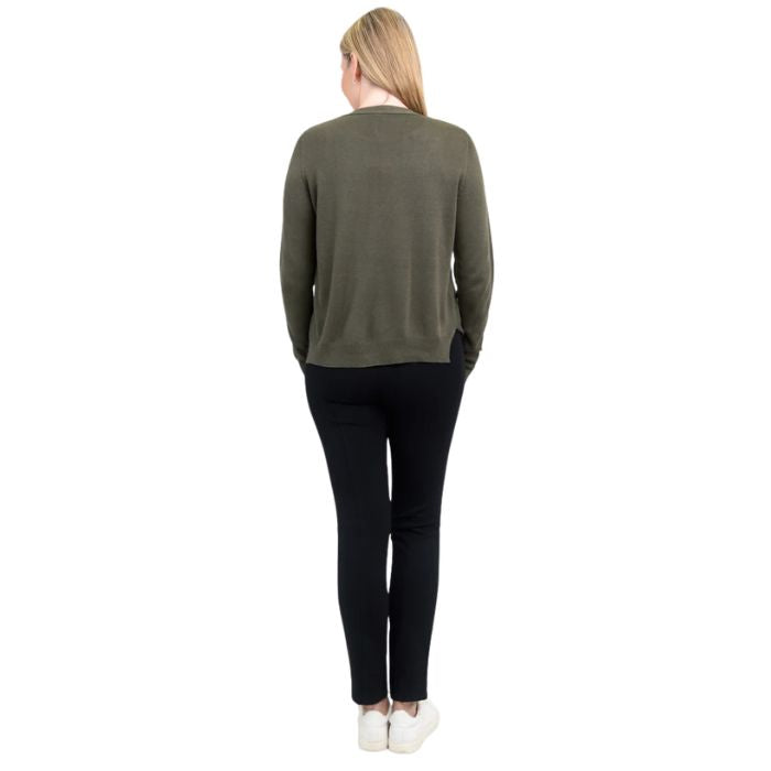 female model wearing khaki green jessica button up cardigan sweater, white reanna tank top and black nadia pants back view on white background