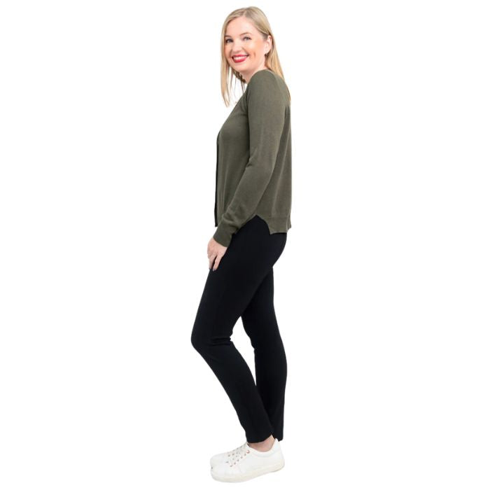 female model wearing khaki green jessica button up cardigan sweater, white reanna tank top and black nadia pants side view on white background