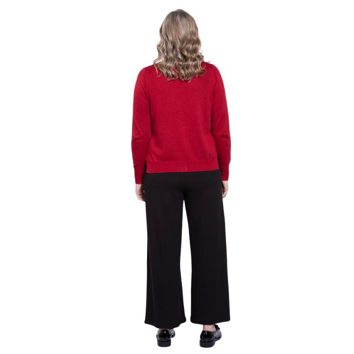 female model wearing lipstick red jessica button up cardigan sweater, black reanna tank top and black landon capri pants back view on white background