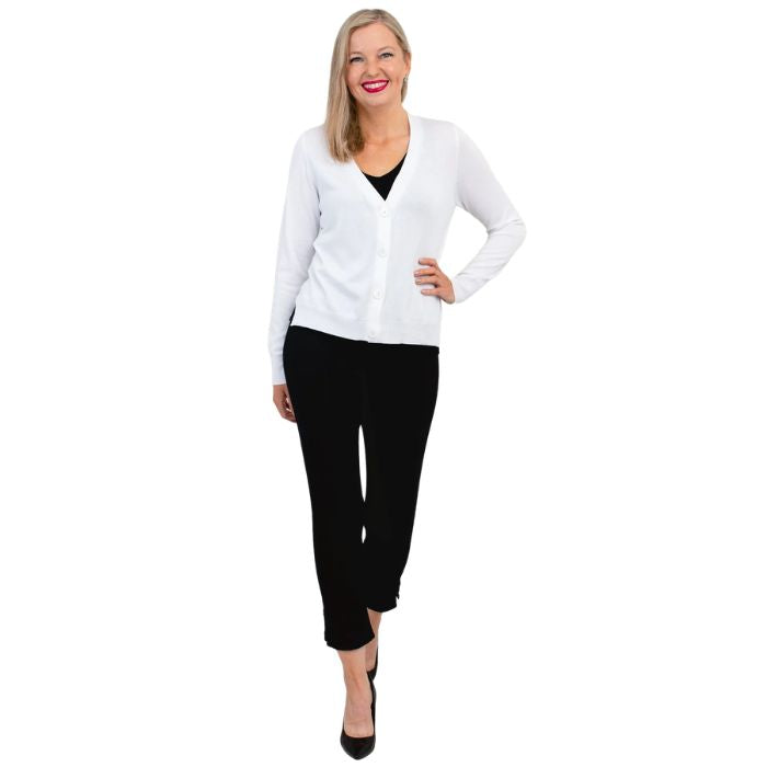female model wearing white jessica button up cardigan sweater, black reanna tank top and black nadine cropped pants front view on white background
