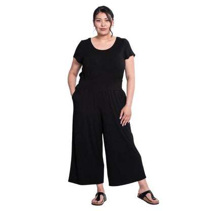 a woman wearing black julie jumpsuit front view on white background