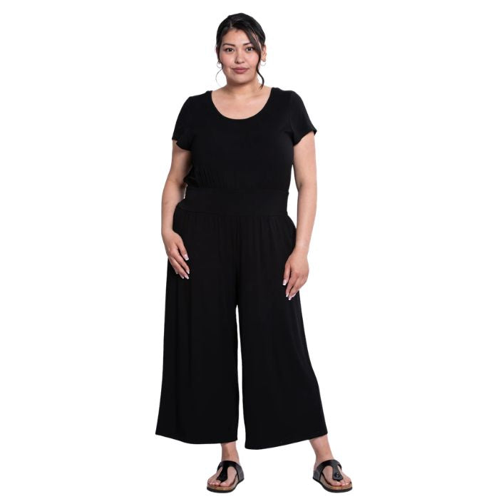 a woman wearing black julie jumpsuit front view on white background