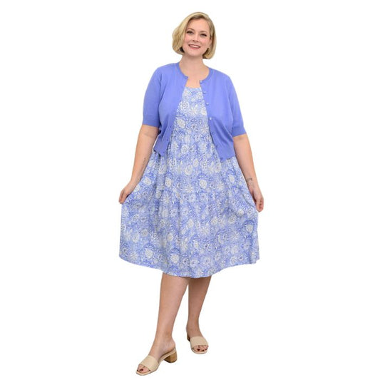 female model wearing peri teatime print  juni dress and blue isabella cardigan front veiw on white background