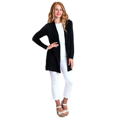 female model wearing justine black draped cardigan sweater reanne white tank top and nadine white croppped pants front view on white background