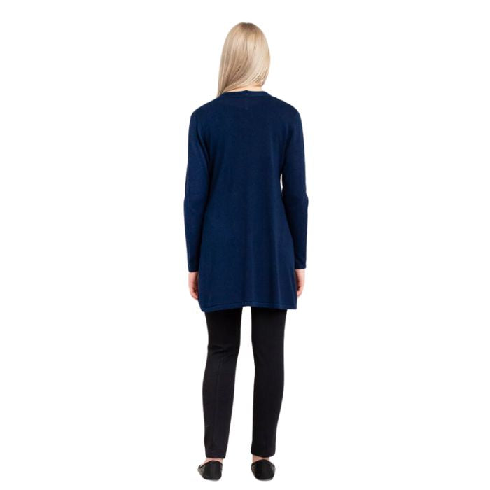 female model wearing justine indigo blue draped cardigan sweater, jazz black tank top and nadia black pants front view on white background