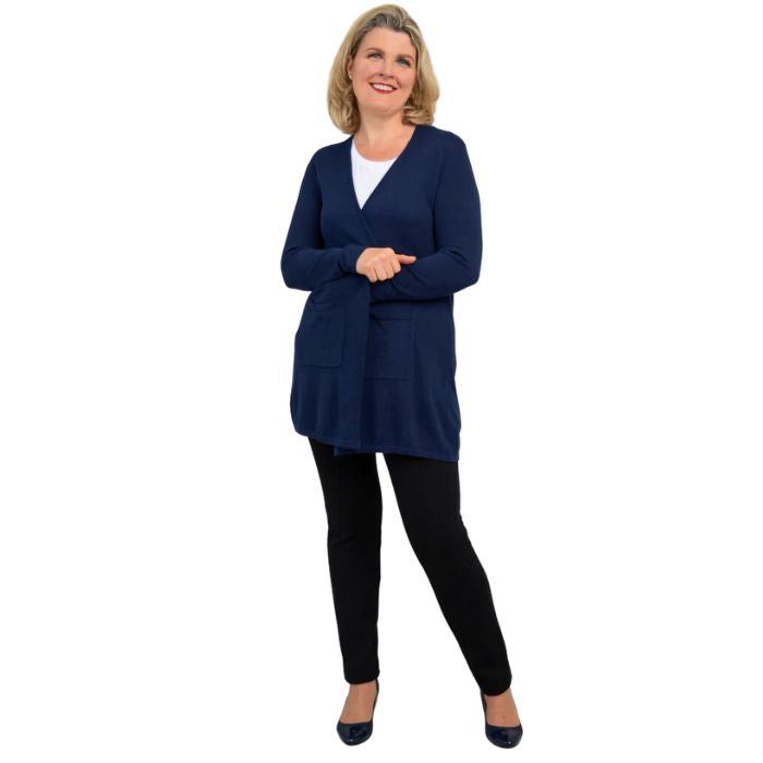 female model wearing justine indigo blue draped cardigan sweater, jazz white tank top and nadia black pants front view on white background