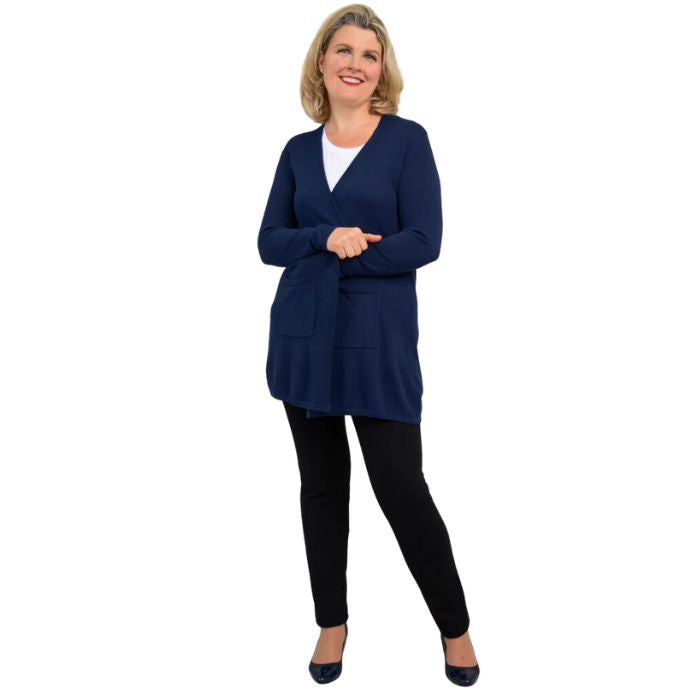 female model wearing indigo blue justine draped cardigan sweater, white jazz tank top and nlack nadia pants front view on white background