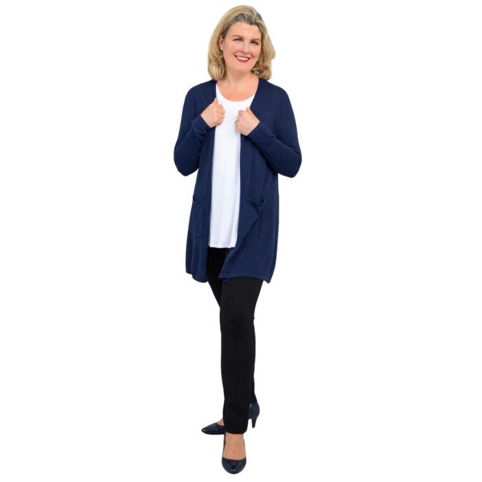 female model wearing indigo blue justine draped cardigan sweater, white jazz tank top and nlack nadia pants front view on white background