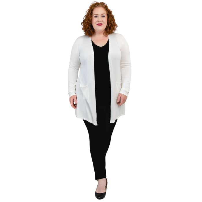 female model wearing justine white draped cardigan sweater over reanna white tank top and nadia black pants  front view on white background