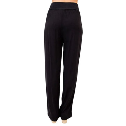female model wearing black landon pants back view on white background