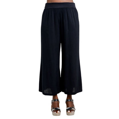 female model wearing black landon capri pants front view on white background