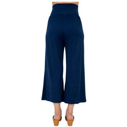 female model wearing indigo blue landon capri pants back view on white background