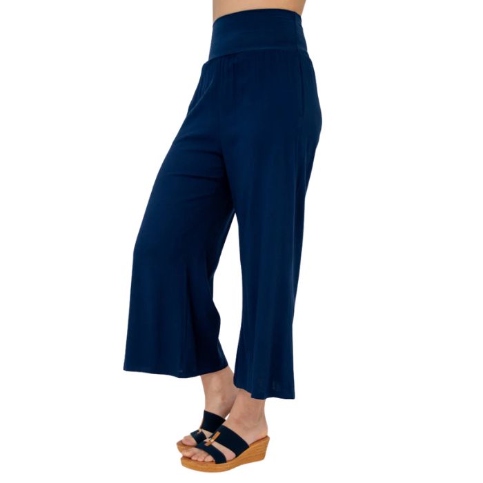 female model wearing indigo blue landon capri pants side view on white background