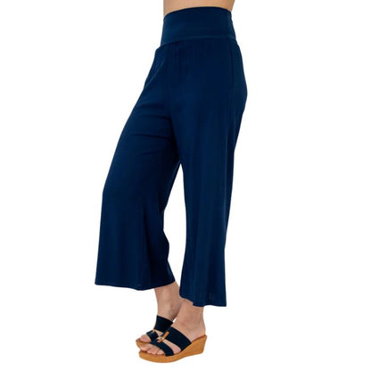female model wearing indigo blue landon capri pants side view on white background