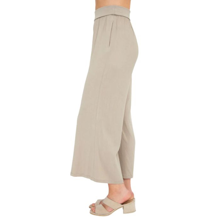 female model wearing sand brown landon capri pants side view on white background
