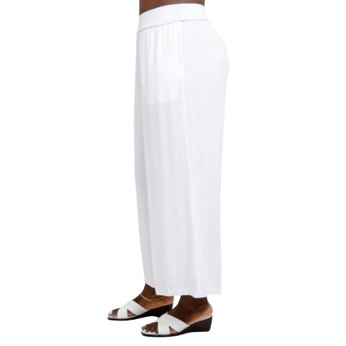 female model wearing white landon capri pants side view on white background