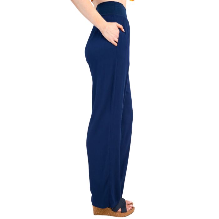 female model wearing indigo blue landon pants side view on white background